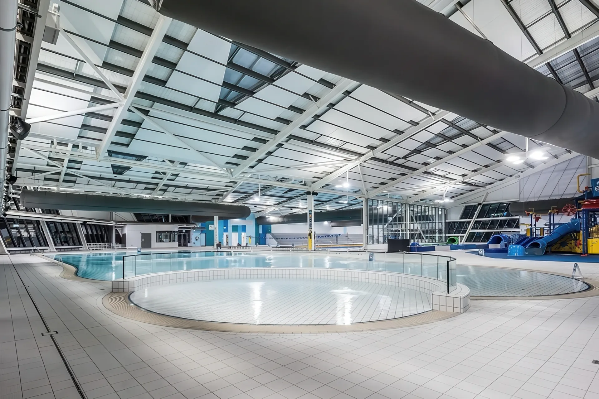 Aquatic centre interior with leisure pools and skylit roof